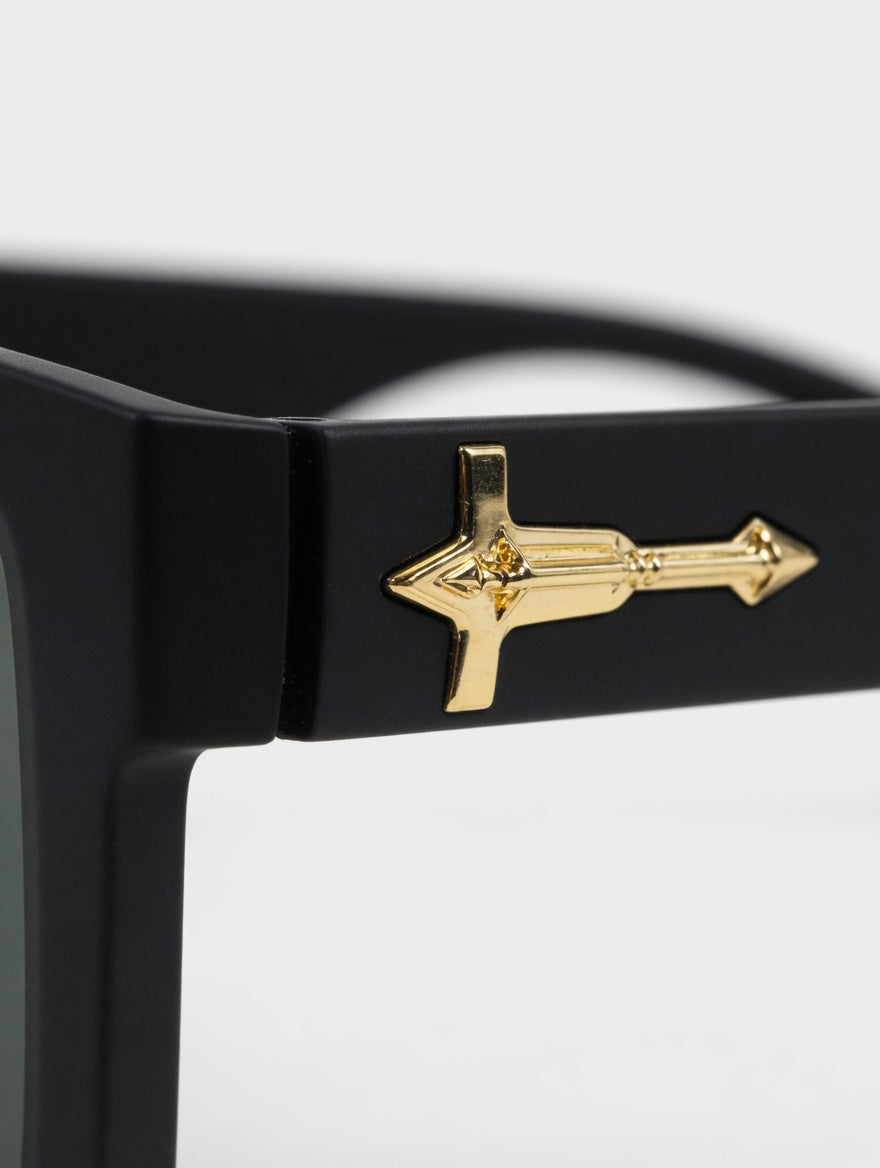 Black sunglasses with a gold decorative element on a white background