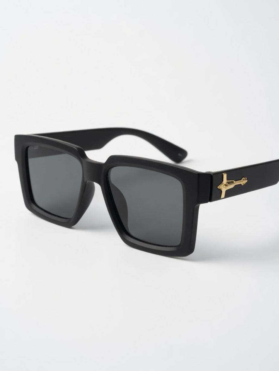 Black sunglasses with gold accents on a white background